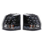 Rear tail light pair with clear lenses, black housing, chrome reflectors, amber markers