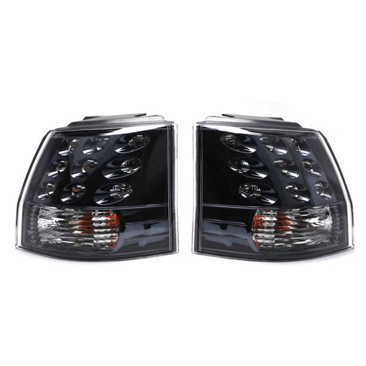 Rear tail light pair with clear lenses, black housing, chrome reflectors, amber markers