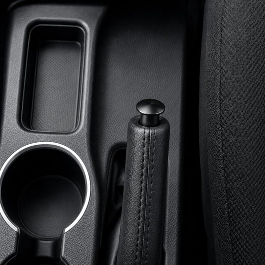 Aluminum alloy handbrake release button cover, black cap with black leather-wrapped grip.
