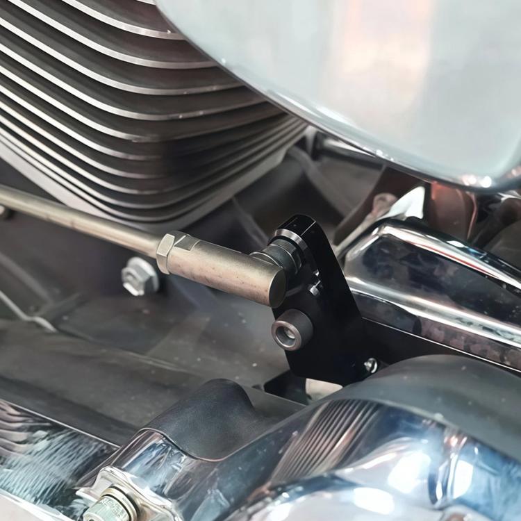 Black speed adjustment assist bracket mounted on motorcycle near engine