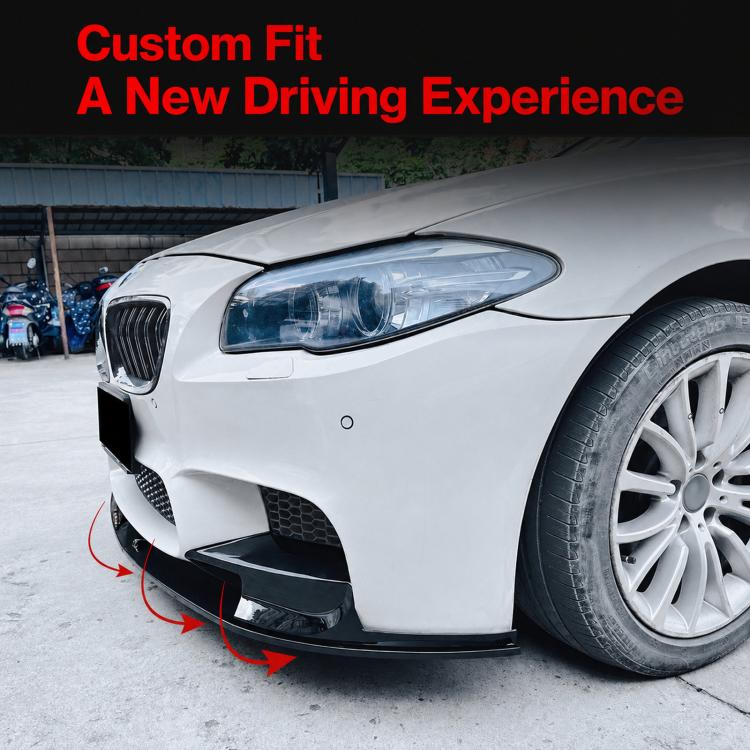 Installed carbon-fiber style front lip and trim on a white BMW front bumper