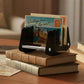 Black acrylic mail organizer with multi slots and clear support bars on stacked books