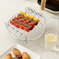 Stainless grill rack with skewers of meat and vegetables