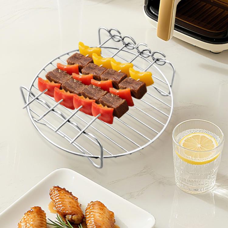 Stainless grill rack with skewers of meat and vegetables
