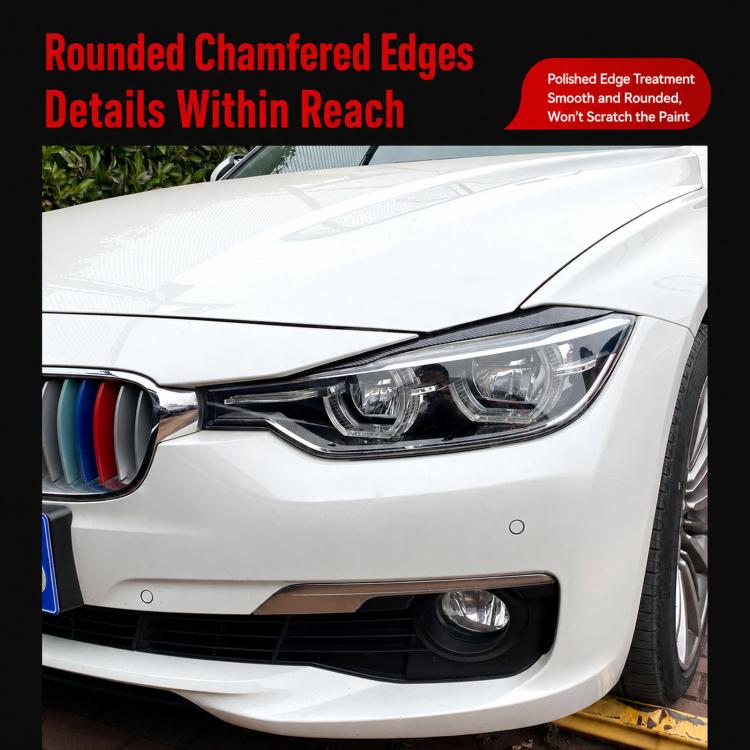 Installed headlight eyebrow decals on a BMW front headlamp, dark curved trim pieces