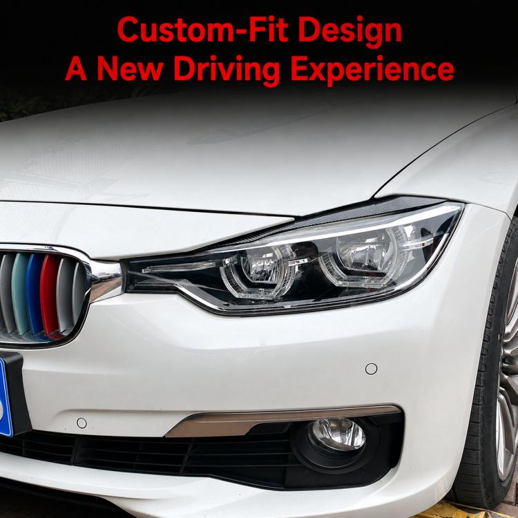 Installed headlight eyebrow decals on BMW front headlamp with dark curved edge trim