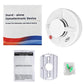White standalone smoke alarm with red status light, shown next to packaging materials