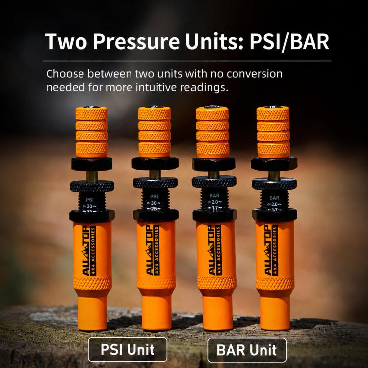 Set of orange tire deflators with black connectors showing PSI and BAR units
