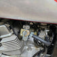 Installed fuel valve switch on motorcycle engine, lever and fuel hose visible