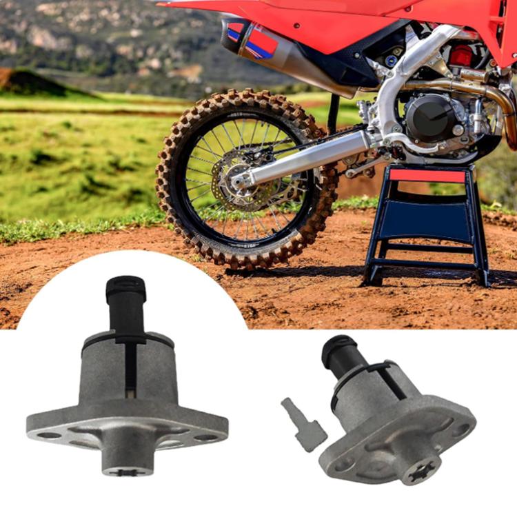 Cam chain tensioner and mounting base, gray metal housing with black cylinder, two views.