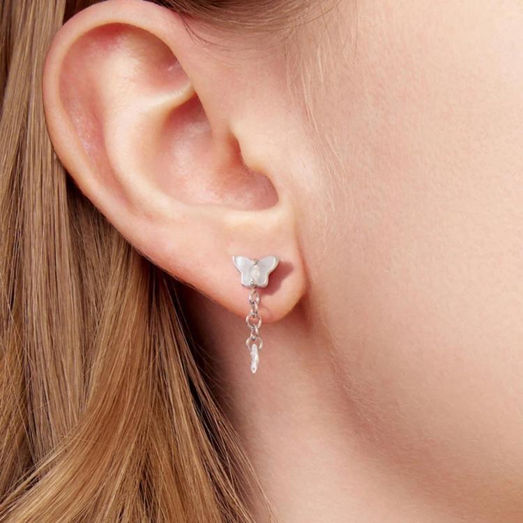 Butterfly stud teardrop crystal drop earrings with linked tassel on model ear