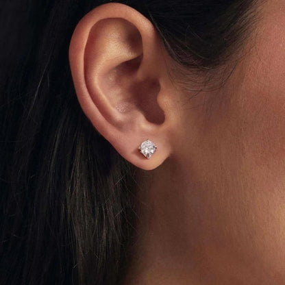 Sterling silver square moissanite stud earrings with sparkling center stone, worn