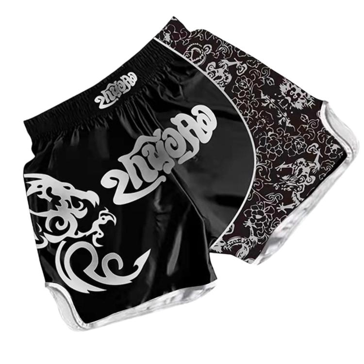 Black and white Muay Thai boxing shorts with gold ornate pattern and dragon motif