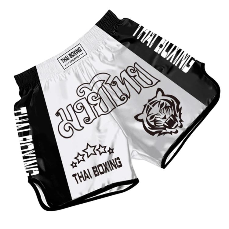 White and black Muay Thai boxing shorts with lion emblem and Thai Boxing text