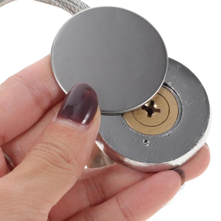 Garage emergency lock cover and key cylinder, shown close-up in hand