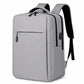 Light gray laptop backpack with zip front pocket, side panel, and padded shoulder straps