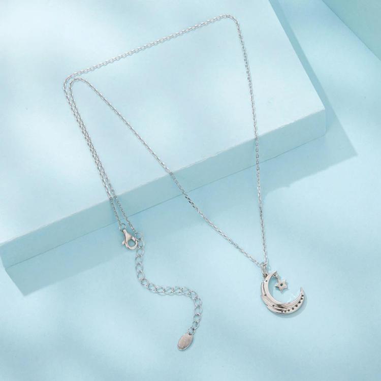 Star and moon pendant necklace with crescent charm and small star, silver-tone chain