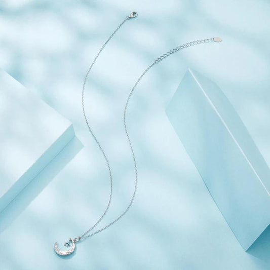 Star and moon pendant necklace with crescent moon charm, silver-tone chain