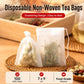 Set of white disposable non-woven tea filter bags with drawstring closures