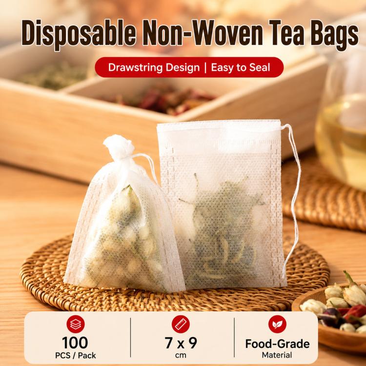 Set of white disposable non-woven tea filter bags with drawstring closures