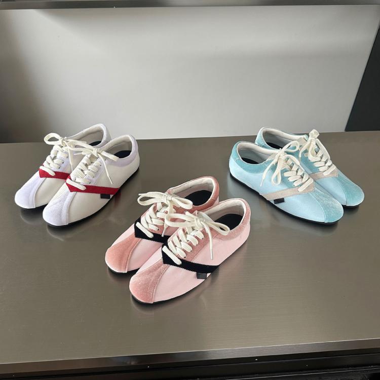 Set of sneakers: white pair with red stripe, pink with black stripe, blue pair