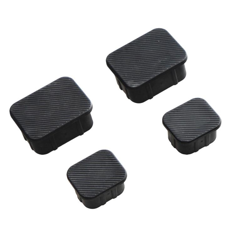 Black rubber plug covers with ribbed tops, four rectangular caps