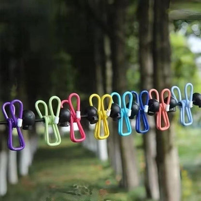 Portable elastic clothesline rope with colorful non-slip clips on a line outdoors