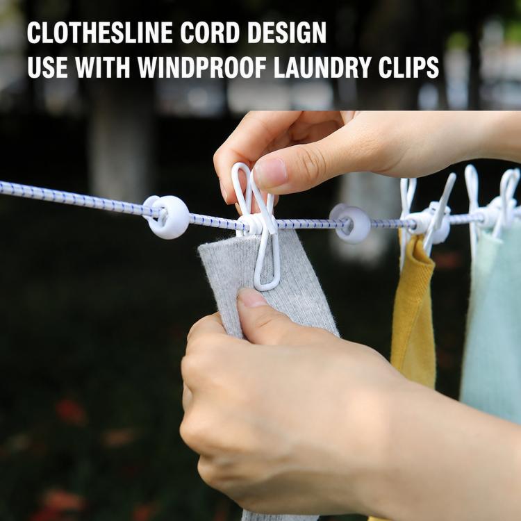 Hand clips a small towel onto an elastic clothesline rope