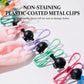 Plastic-coated metal laundry clips with colored frames and black ends on a cloth