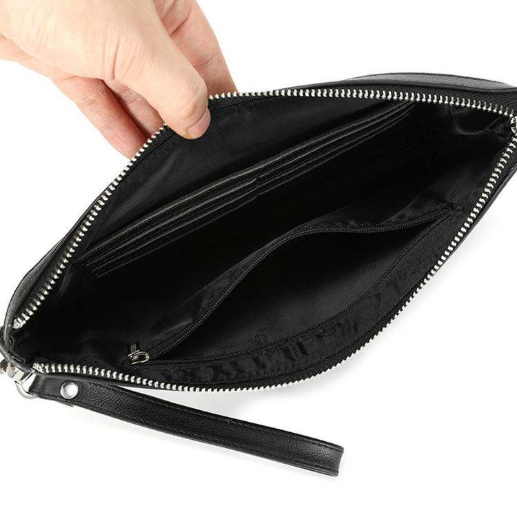 Black leather wristlet clutch bag interior with zippered opening and lined compartments.