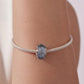 Blue glitter glass bead bracelet on wrist with silver star-toned metal bead