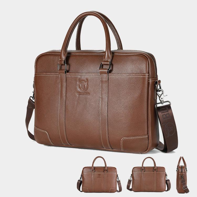 Brown leather briefcase with top handles and front pocket, shown with matching strap