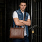 Brown leather briefcase on body with top handles and crossbody strap