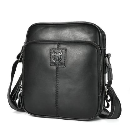 Men's black leather crossbody bag with zip top and front logo patch.