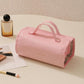 Pink roll-up makeup organizer bag with carry handles and detachable clear compartments
