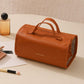 Orange roll-up makeup organizer bag with carry handles and detachable clear compartments