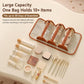 Orange roll-up makeup organizer with four clear compartments holding cosmetics bottles