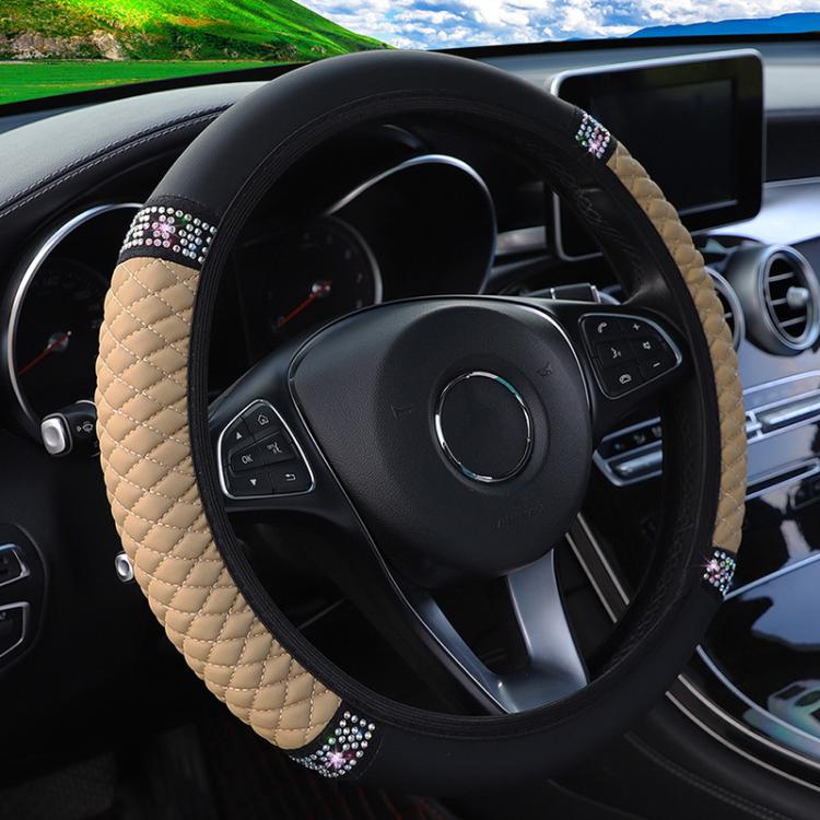 Beige quilted steering wheel cover with black edge and rhinestone studded band