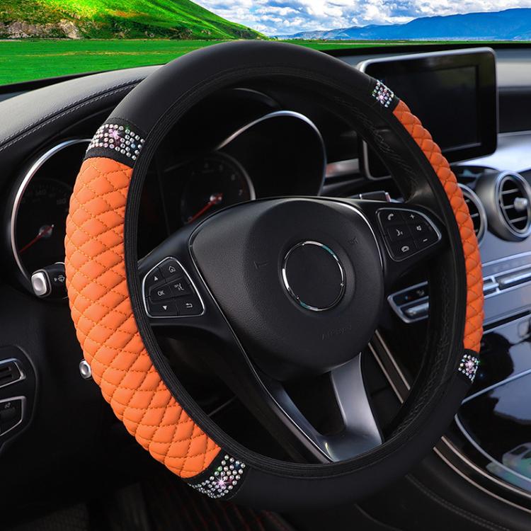 Orange quilted steering wheel cover with black edge and rhinestone studded trim