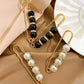 Mixed black and white pearl safety pin waist tightener clips with gold-tone details