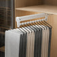 Extendable top-mount closet hanger rail, white bar with black hooks holding pants/scarves