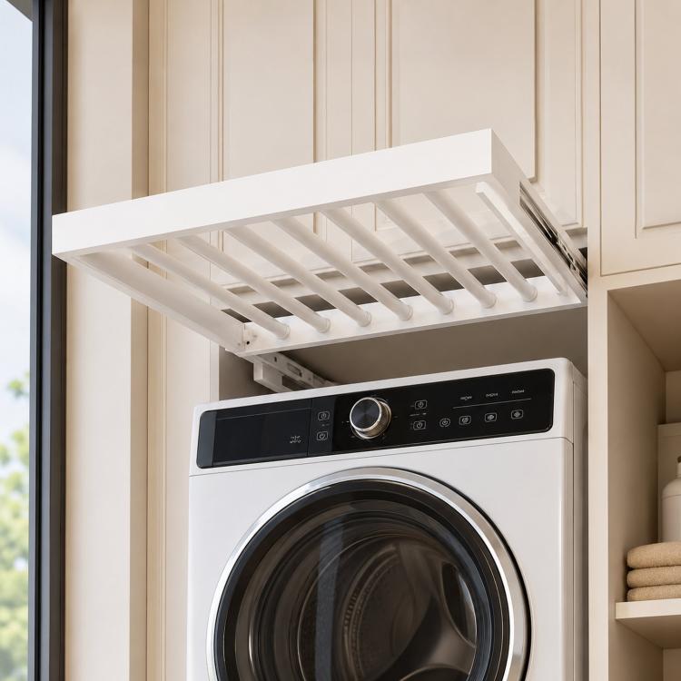 White aluminum drying rack with slotted rods mounted above a washer door