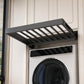 Dark gray drying rack with rod slots mounted on a washer with round door