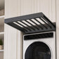 Pull-out laundry drying rack with dark gray slatted rods above washer control panel