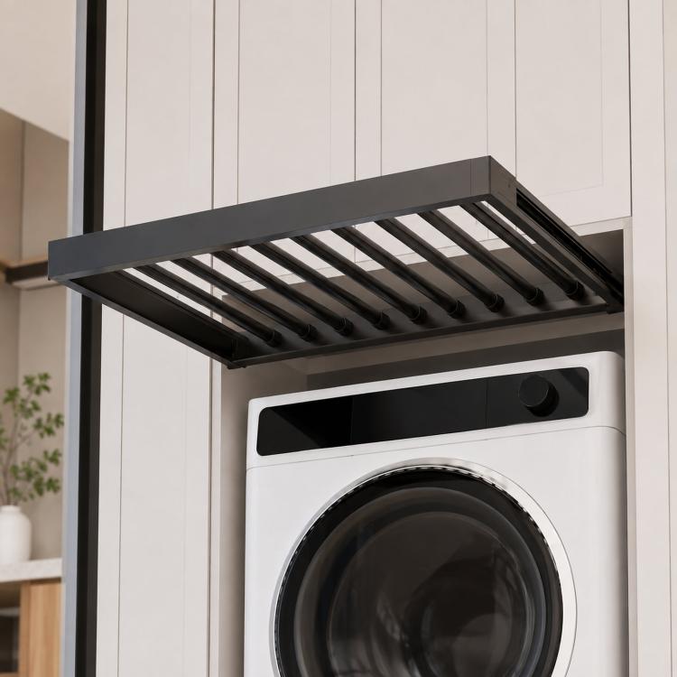 Dark gray pull-out laundry drying rack over a top-loading washer with slatted drying rods