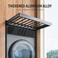 Gray pull-out laundry drying rack with slatted rods, extended over a front-loading washer