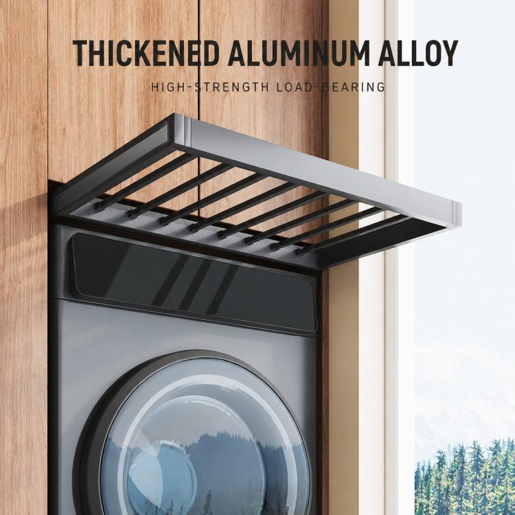 Gray pull-out laundry drying rack with slatted rods, extended over a front-loading washer