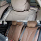 Brown rear seat belt guide clip set installed on beige leather seats