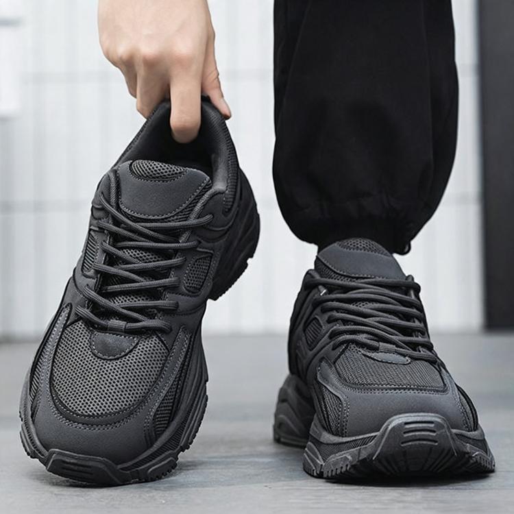 Men's grey lace-up sneakers held by heel with thick treaded sole