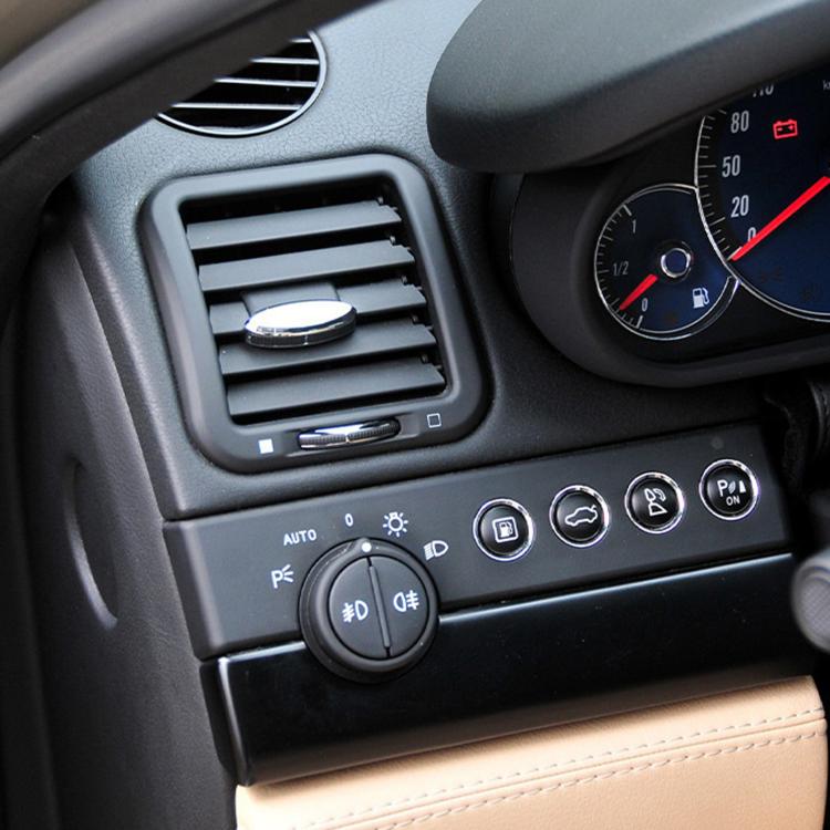 Air vent adjustment paddle installed in car dashboard vent, black base with chrome trim.